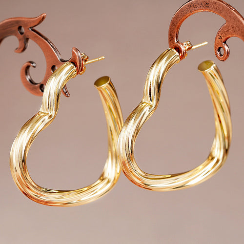 Alternate close view of the gold tone earrings