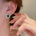 Green Oval Crystal Stud Earrings with Silver Tone Border view 3