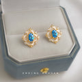 Gold Tone Geometric Halo Blue Oval Stone Stud Earrings view 1