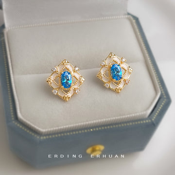 Gold Tone Geometric Halo Blue Oval Stone Stud Earrings
