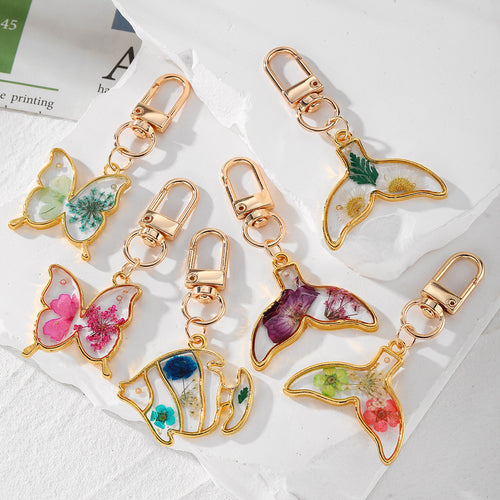 Main product view of gold Tone Butterfly and Fishtail Pressed Flower Clip Keychains