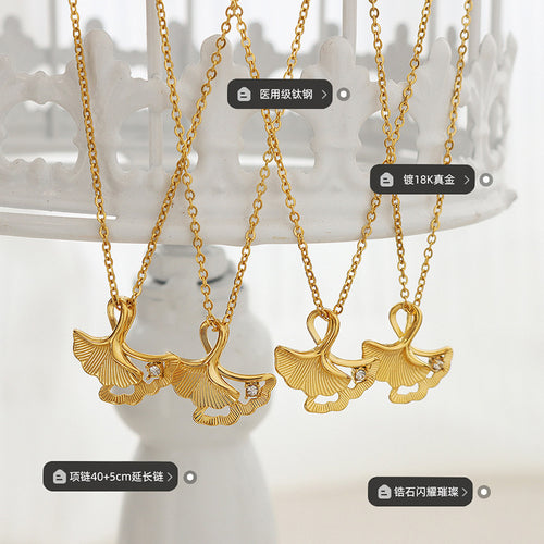 Four gold ginkgo pendants hanging with material size zircon labels