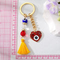 Gold Tone Red Evil Eye Heart Bead and Tassel Keychains view 3