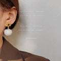 Gold Snowflake Stud Earrings With White Fur Pom Drop view 2