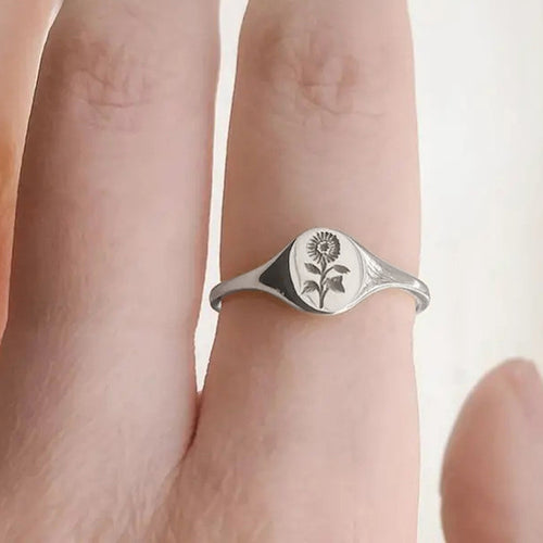 Second product view showing engraved sunflower oval-crest ring