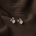 Gold Tone Curved Branch White Flower And Clear Stone Stud Earrings view 3