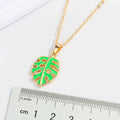 Gold Tone Green Monstera Leaf Necklace and Huggie Earring Options view 5
