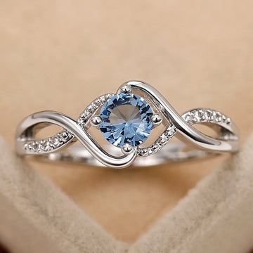 Blue Round Solitaire Wave Ring In Polished Silver Tone