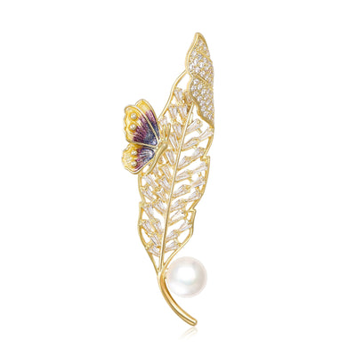 Gold Tone Leaf And Butterfly Brooch shown on a clean white display
