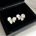 White Enamel Bow Stud Earrings With Gold Center Knot view 4