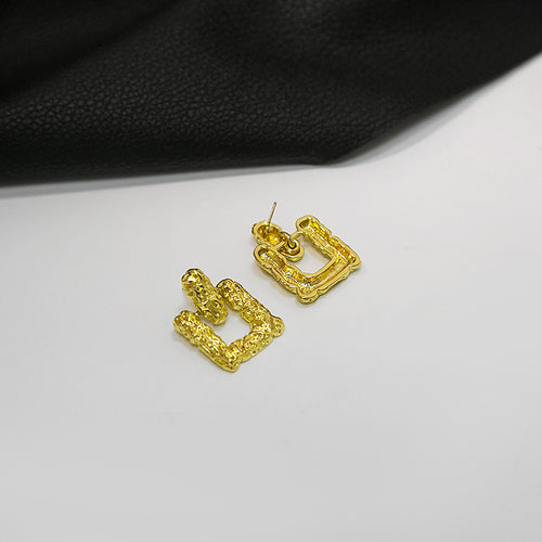 Gold textured open square studs side angle showing posts on white