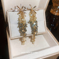 Gold Tone Starburst and Crystal Cascade Drop Earrings view 3