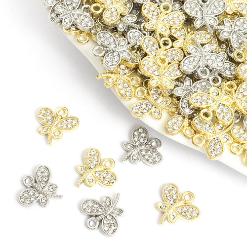 Assorted dragonfly charms arranged on a white surface