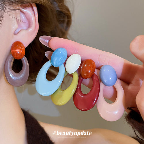 Bold open oval resin drops in blue, olive green, and red colorways, display view