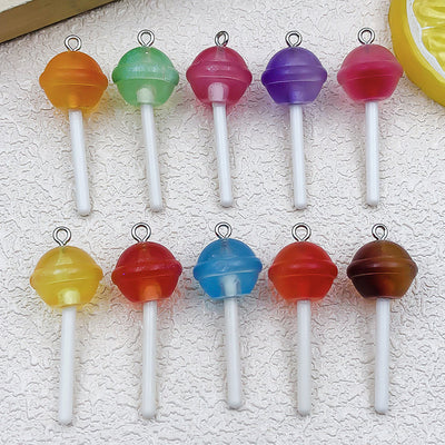 Clear lollipop charms arranged on a light background