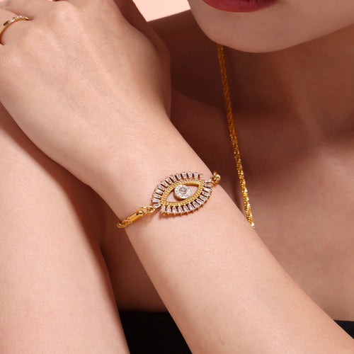 Gold evil eye zircon bracelet on model wrist close-up
