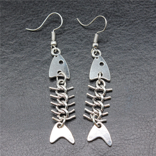 Close-up of jointed fish skeleton earrings showing jointed fish skeleton drops on fishhook ear wires