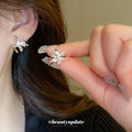 Sculptural Lily Flower Metal Stud Earrings With Decorative Metal Accents view 2