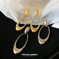 Open Oval Sculptural Drop Earrings In Gold And Silver Tone view 1