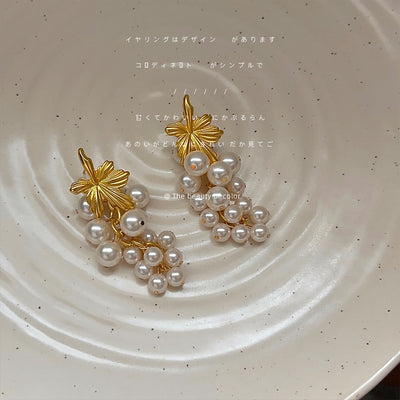 Gold matte grape leaf pearl cluster drops on speckled cream plate