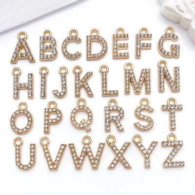Orange alphabet letter charms arranged on a light background