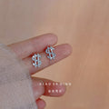 Silver Tone Clear Pave Dollar Sign Mini Stud Earrings view 1