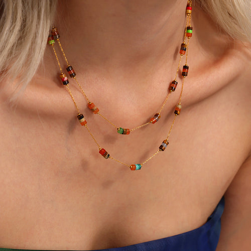 Layered gold multicolor stone bead necklaces on blonde model