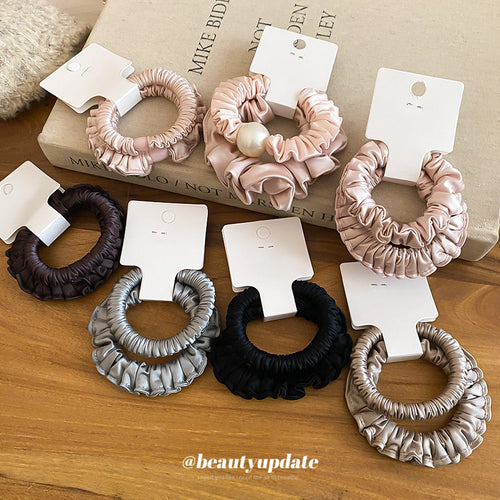 Satin scrunchies in pink black coffee and gray on wood table