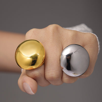 Gold and steel large dome statement rings worn on fist