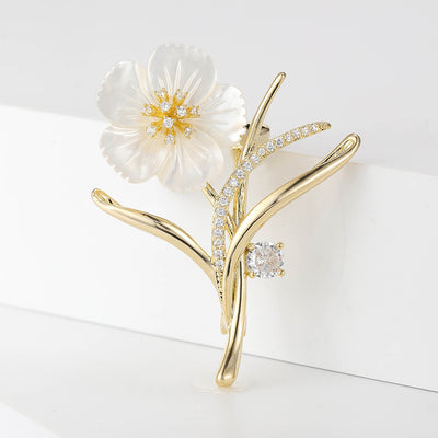Front view of white shell flower branch brooch with crystal buds