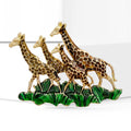 Three Giraffes Enamel Brooch Walking Across Green Grass view 2