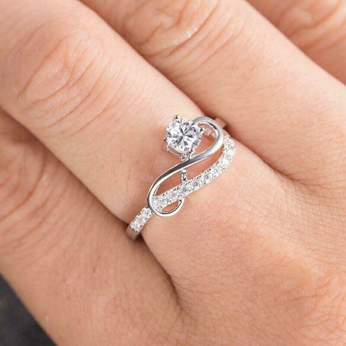 Second product view showing silver-tone round clear solitaire swirl pave ring