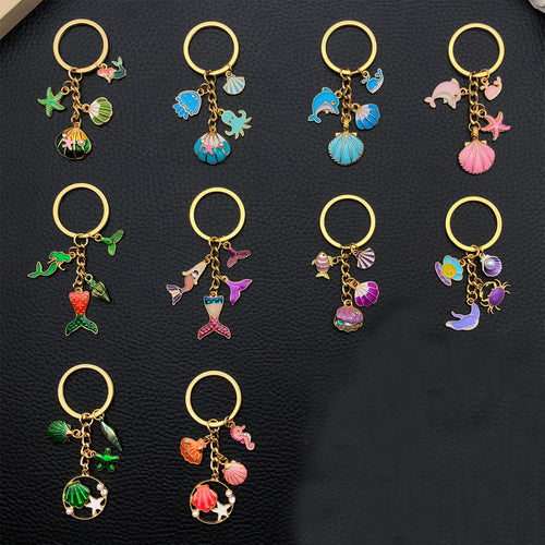 Alternate arrangement of the nine colorful ocean animal and mermaid metal keychain showing its hardware and charm detail