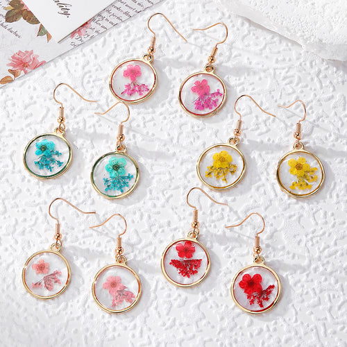 Five pairs of gold round bezel pressed flower resin earrings in assorted colors
