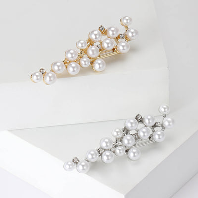 A slim branching vine dotted with white pearls and crystals shown on a white background.