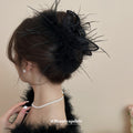 Black Feather Hair Claw With Sheer Fabric Loops And Loose Strands view 1