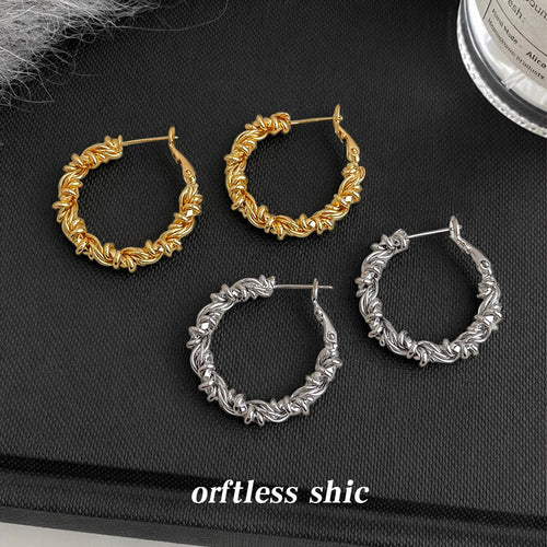 Twisted-rope large hoops in gold and silver tone shown as both metal colors.