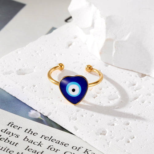 Close-up showing the colors and surface details of gold Tone Blue Evil Eye Adjustable Rings in Seven Shapes