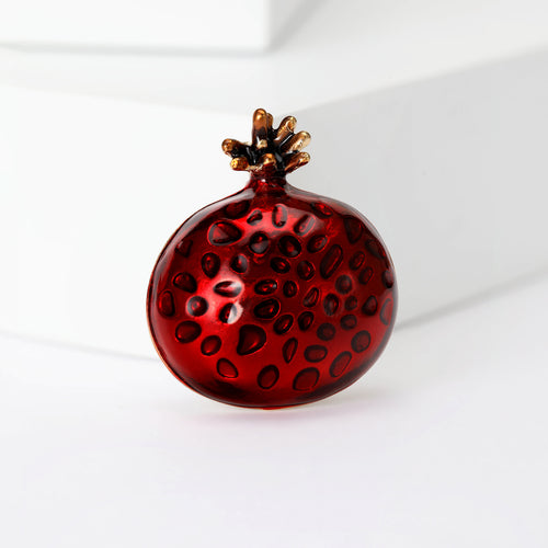 Pomegranate brooch close-up seed texture