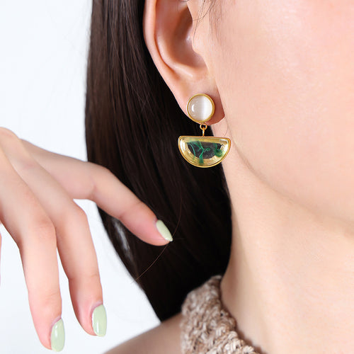 Gold cats eye green resin half moon drop earring worn on model