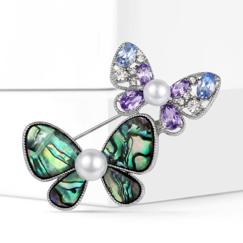 Close-up product view showing the colors and surface details of the green and purple double butterfly brooch