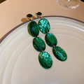 Emerald Green Oval Crystal Drop Earrings With Polished Metal Tone Details view 6