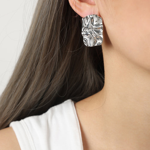 Silver steel wrinkled square stud earring worn on ear profile