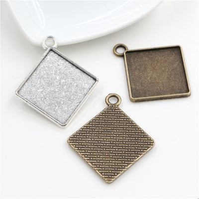 textured back square cabochon pendant trays arranged together on a white background