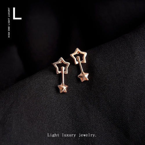 Rose gold hollow star jacket studs on black fabric with luxury logo