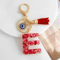 Red Resin Shell Letter Keychain with Evil Eye and Tassel view 9