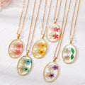 Gold Tone Oval Resin Pressed Flower Pendant Necklaces in Six Colors view 1