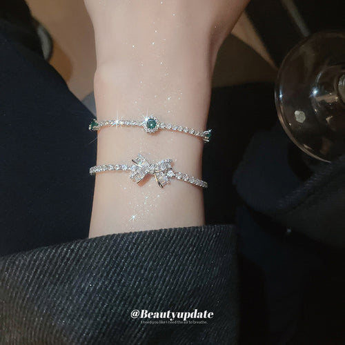 silver-tone clear crystal bow slider bracelet with an unlisted green style shown in the first close product view