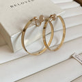 Oversized Polished Hoop Earrings with Distinctive Textured Details view 8