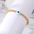 Gold Tone Beaded White Blue Evil Eye Stretch Bracelet view 1
